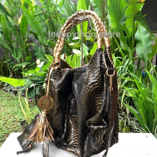 Black and gold hobo bag with gold handles by Indopython