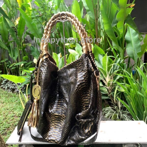 Black and gold hobo bag with gold handles by Indopython