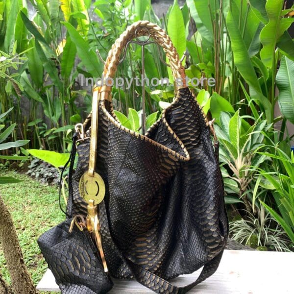 Black and gold hobo bag with gold handles by Indopython